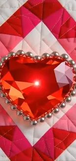 Heart-shaped red gemstone with silver beads on a pink quilt pattern.