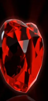 Red heart-shaped gem on black background.