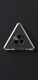 Dark wallpaper with a metallic radiation symbol.