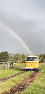 Yellow van under a rainbow on a country road.