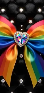 Rainbow heart bow against black leather with diamonds.
