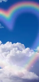 Rainbow heart floats in a bright blue sky filled with fluffy clouds.