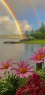 Vibrant rainbow over lake with pink flowers in foreground.