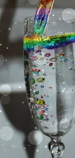 Rainbow liquid pouring into sparkling champagne glass.