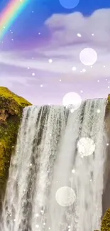 Waterfall with rainbow under a serene sky.