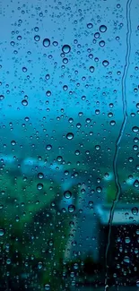 Raindrops on a window with a blue landscape background