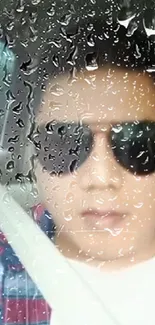 Mobile wallpaper with raindrop effect over portrait wearing sunglasses.