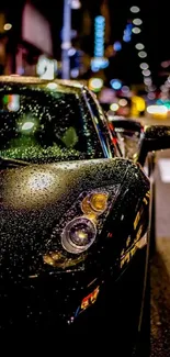 Black car at night with raindrops on hood, illuminated by city lights.