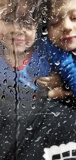 Children smiling behind rain-covered glass with reflections.