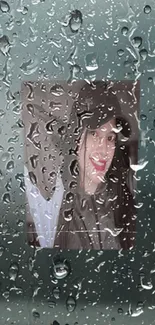 Rain-covered glass with a portrait behind.