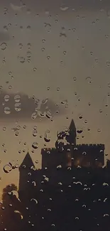 Castle silhouette through raindrop-covered glass.