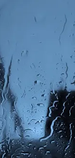 Raindrops on glass with blue background.