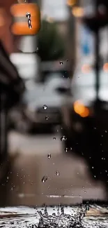 Raindrop in focus against blurred urban background wallpaper.