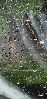 Raindrop covered window with waterfall in background.