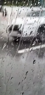 Mobile wallpaper of rain droplets on a window with a blurred background.