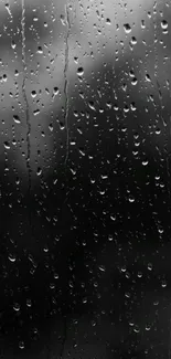 Rainy window mobile wallpaper in black and white, highlighting raindrops.