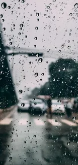 Raindrops on a window with an urban street scene in the background.