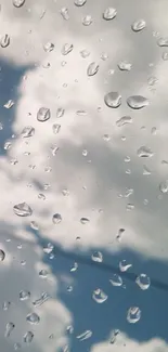 Raindrops on a window with cloudy sky.