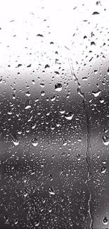 Wallpaper of raindrops on a window in grayscale.