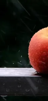 Vibrant apple with raindrops on a dark background wallpaper.