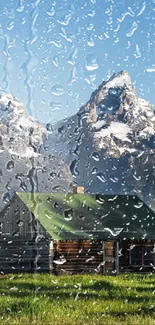 Rainy view of a cabin with mountain backdrop.