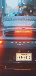 Sports car on rainy city street with vibrant brake lights.