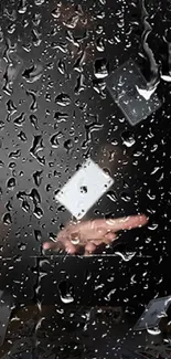 Playing cards behind raindrop-covered glass, evoking a magical effect.