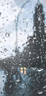 Raindrops on window overlooking a moody city street scene.