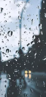 Raindrops on window with blurred city lights in the background.