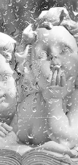 Cherub statues behind a rainy glass surface, creating a soothing wallpaper effect.