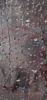 Raindrops on glass with superhero silhouette in background.