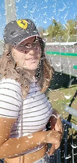 Woman smiling amid raindrops on a clear window background.