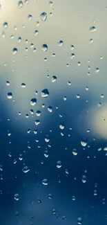 Raindrops on glass with a calming blue hue, perfect for a serene wallpaper.