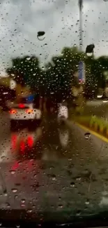 Raindrops on a car windshield with city lights reflecting on a rainy street.