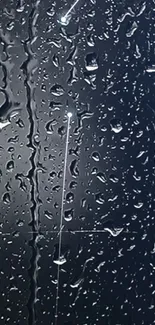 Raindrops on a glass surface with a dark blue background.