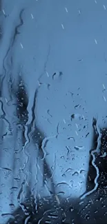 Rainy glass with blue hues mobile wallpaper.