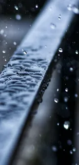 Close-up of a rainy metal rail with water droplets in focus.