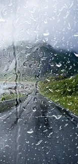 Mobile wallpaper of a rainy road with a mountain view.