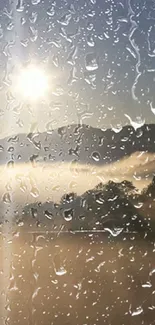 Misty mountain landscape through rain-covered glass with a rising sun.