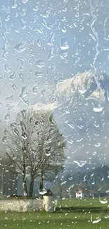 Raindrops on glass with mountain view and cloudy sky