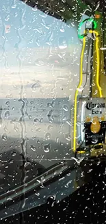 Neon-outlined beer bottle on a rainy window with ocean view.