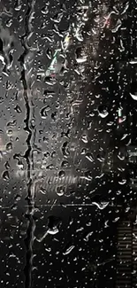 Rainy cityscape at night with raindrops on glass.