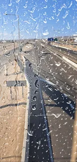 Rainy view of a desert road through a window.