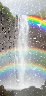 Wallpaper of a rainy waterfall with vibrant rainbows.