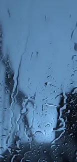 Raindrops on a window with a soothing blue background.