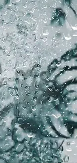 Raindrops on a window with leaf silhouette wallpaper.