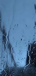 Mobile wallpaper of a rainy window with water droplets.