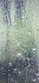 Rainy window mobile wallpaper with blue tones and water droplets.
