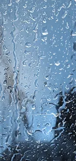 Raindrops on window with blue sky in mobile wallpaper.