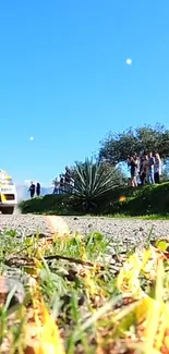 Rally car race in a scenic landscape with blue sky and nature.